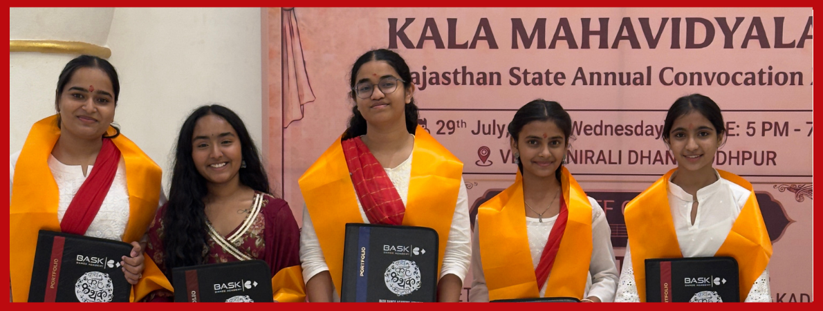 Students seated on stage holding ABSKM certificates at a ceremony